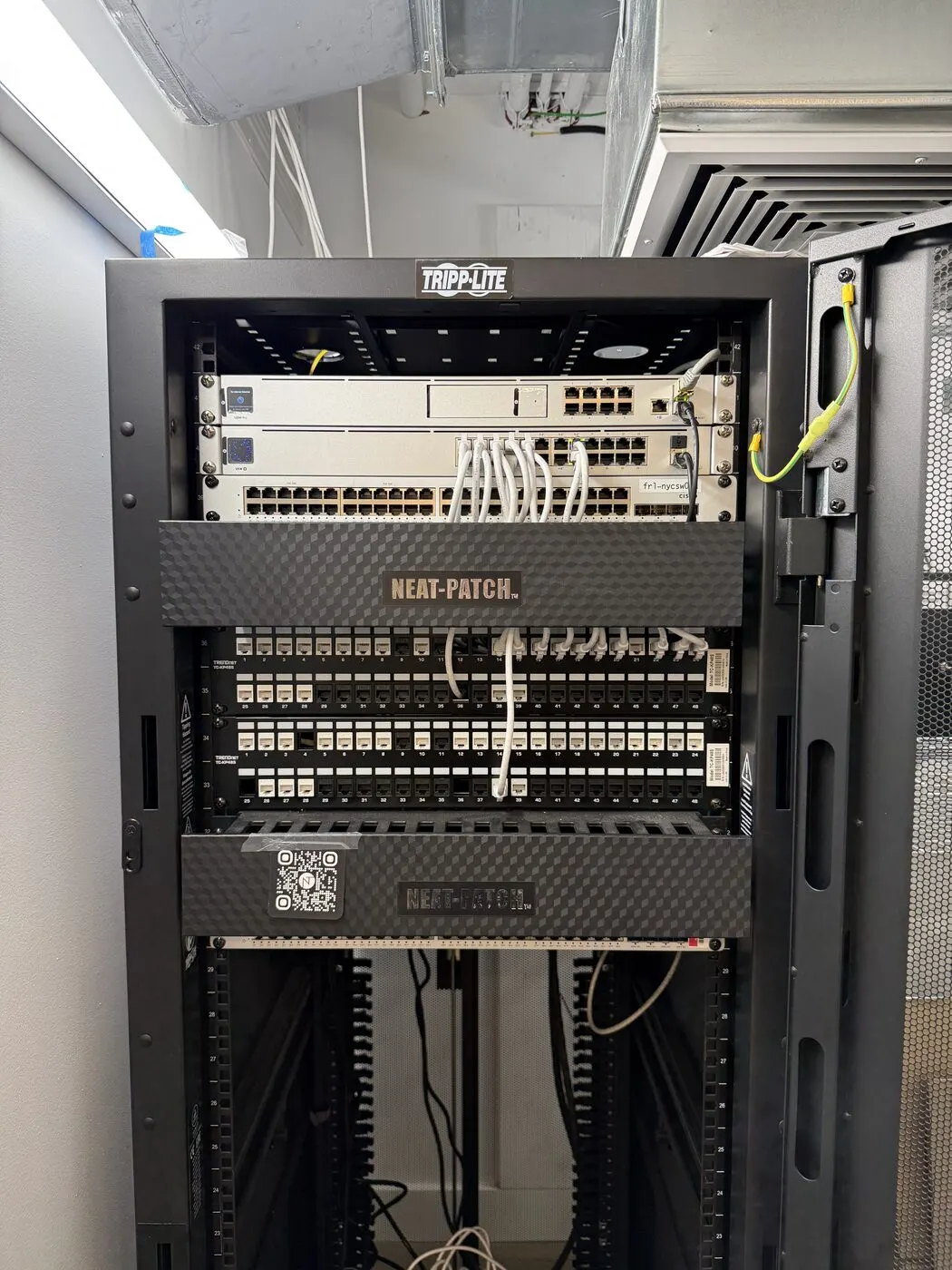 Neat-patched UniFi rack — AI office Wi-Fi near Union Square